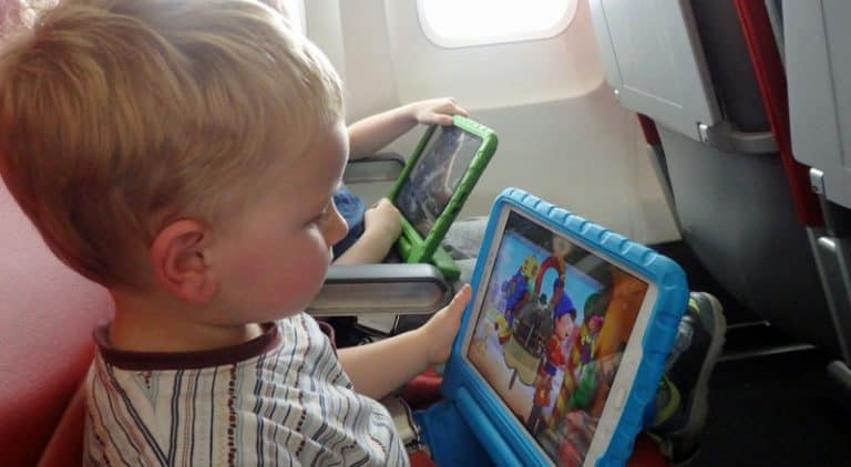 toddler using tablet while flying