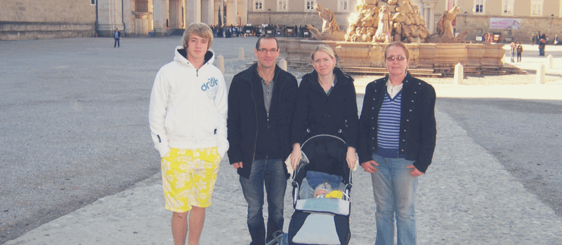 family standing in Salzburg square