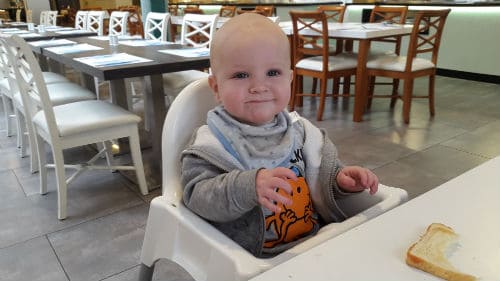 Little boy eating on holiday