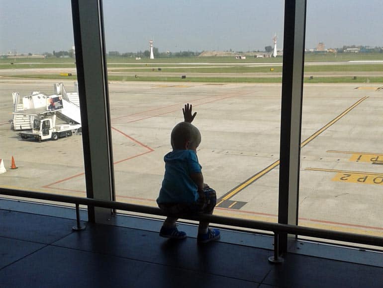 boy watching the planes at the airport