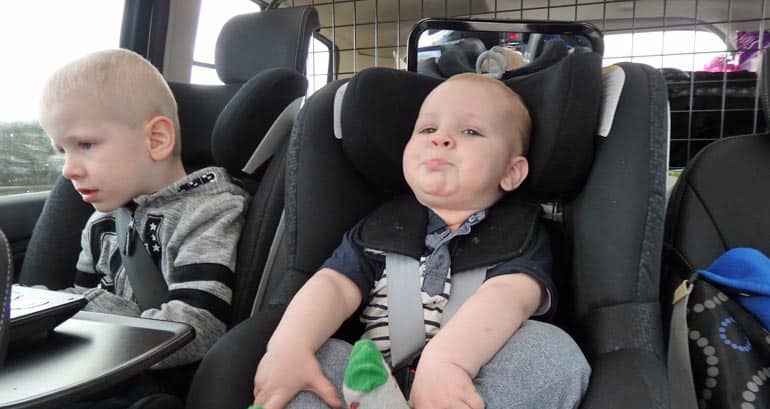 children in a car on a road trip