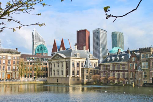 Binnenhof Palace - Dutch Parlamen against the backdrop of modern buildings. Den Haag, Netherlands.