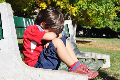 Sad child in the park, outdoor, summer to fall