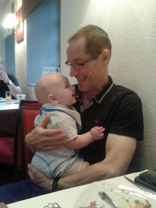 grandchild looking up at his granddad