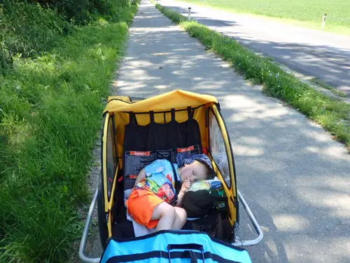 Toddler asleep in bike trailer