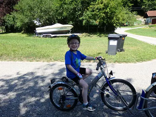 Child on a follow me bike on a family cycling holiday