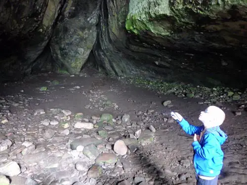 Child exploring Kings Cave in Arran