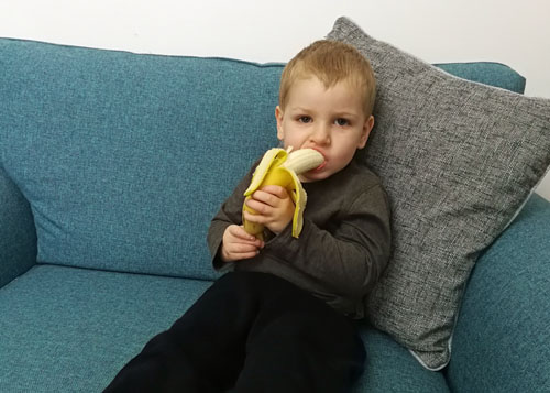 Toddler eating a banana