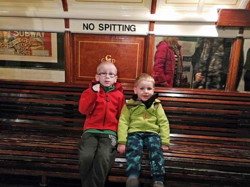 Brothers sitting on a train at Riverside Museum