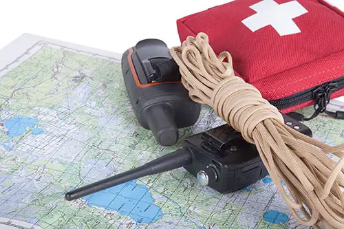 Map, gps navigator, portable radio, rope and first aid kit on a light background. Set lifeguard.