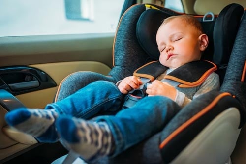 Baby asleep in a car seat