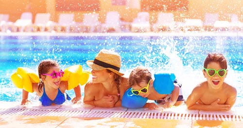 Active happy family having fun in the pool, spending time together in aquapark, summer holidays, joy and pleasure concept