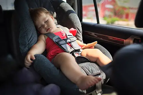 Toddler girl sleeping in child car seat.