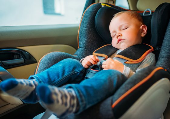 baby sleeping in a car seat