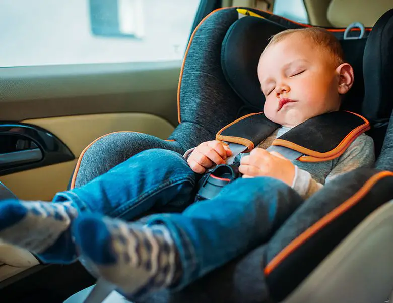 baby sleeping in a car seat