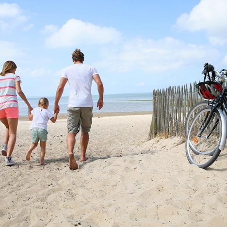 happy family running on a sandy beach