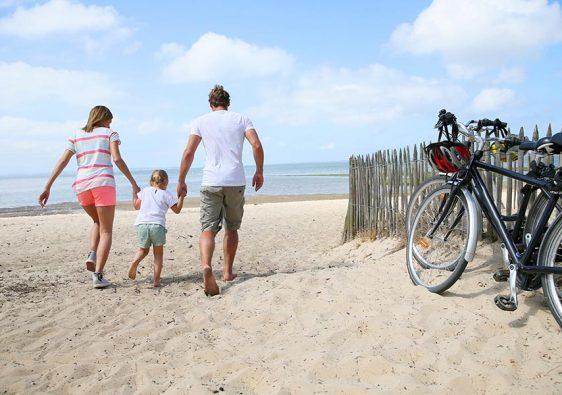 happy family running on a sandy beach