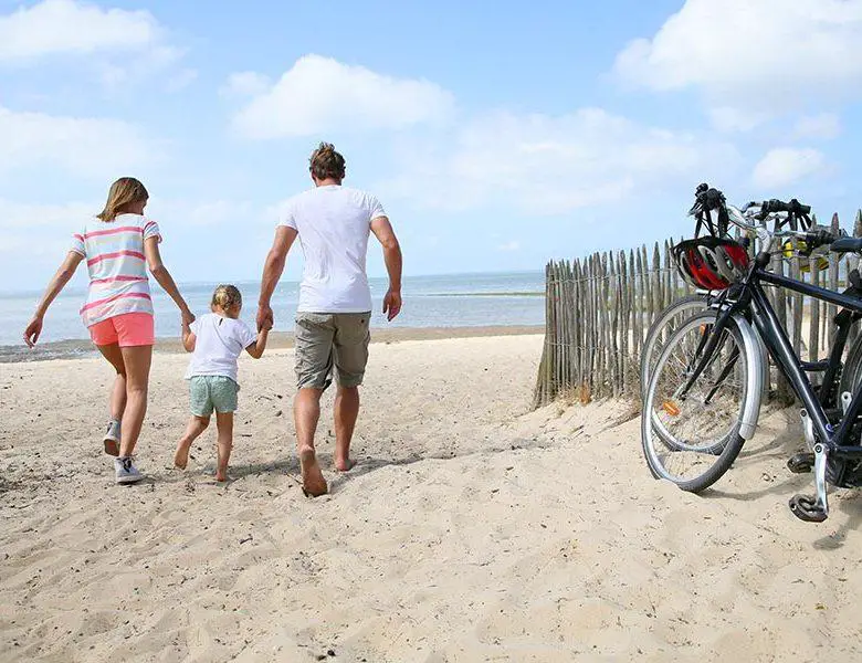 happy family running on a sandy beach