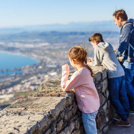 Family with two kids enjoying breathtaking views of Cape Town from top of Table mountain