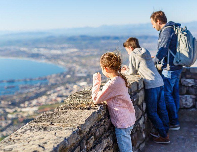 Family with two kids enjoying breathtaking views of Cape Town from top of Table mountain